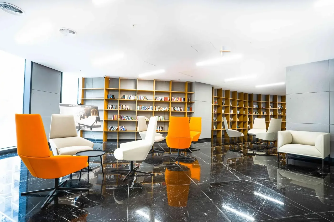 Lounge area with a library at Axis Towers